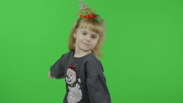 Happy Beautiful Little Girl in a Sweater with a Snowman. Christmas. Chroma Key