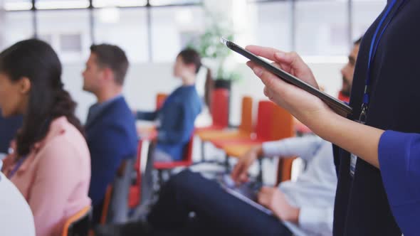 Businesswoman using digital tablet in conference room