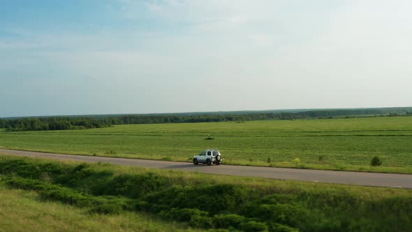 Aerial View of a Car Driving on a Country Road