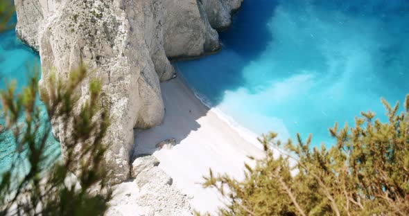 Remote Beach with Huge White Rock Formation with Blue Lagoon Tourist Pleasure Boats