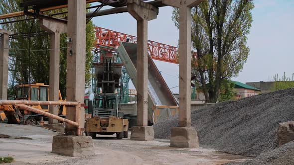 View of the mining quarry. Mining dump truck in stone quarry on the background of hills of crushed s