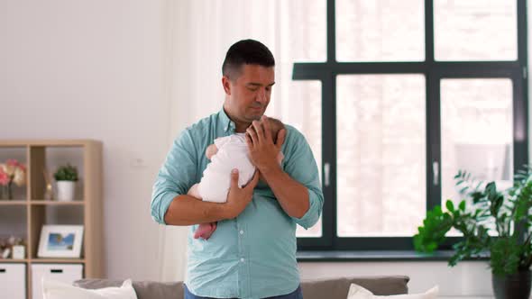 Middle Aged Father with Baby Daughter at Home