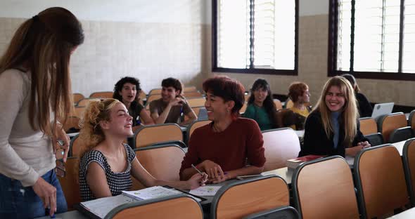 Mature teacher working with students inside classroom at school university