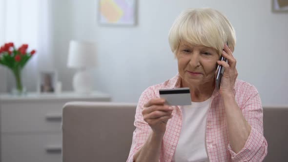 Old Woman Holding Credit Card and Talking Phone, Banking Programs for Old People
