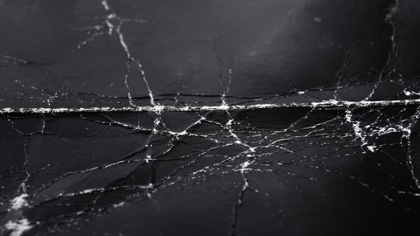 Worn black cardboard with wrinkles and cracks. Paper dark abstract background for design