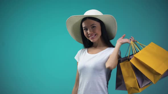 Lady Holding Shopping Bags Showing Credit Card Into Camera, Cashless Payments
