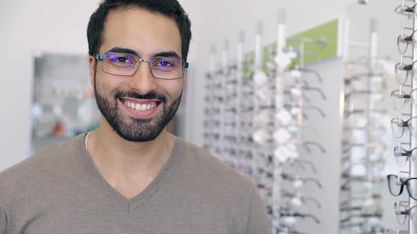 Glasses Shop. Man Trying On Eyeglasses In Optics Store