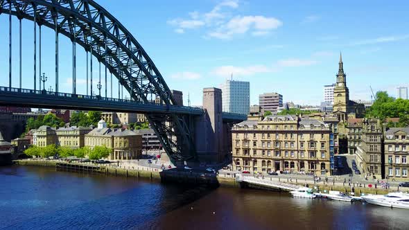 Arial footage of the Tyne bridge and Newcastle skyline in Newcastle Upon Tyne on a sunny day