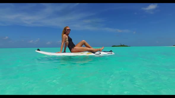 Beautiful women happy and smiling on exotic shore beach vacation by turquoise lagoon with white sand