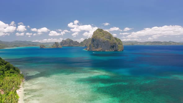 Aerial Drone View of Rocky Pinagbuyutan Island in Open Sea From Wellknown Las Cabanas Beach