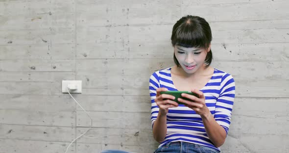 Woman play game on cellphone