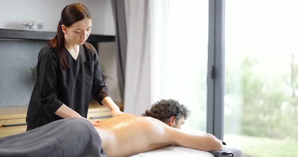 Female Masseur Doing Massage to Male Client