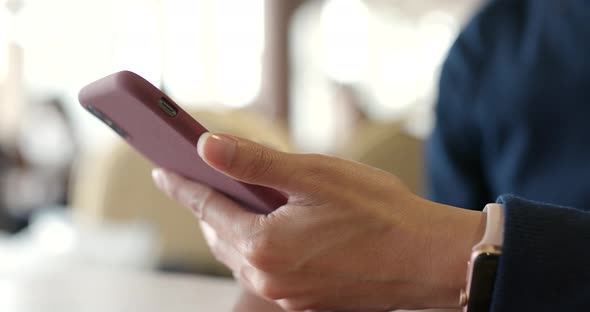 Woman use of mobile phone in restaurant