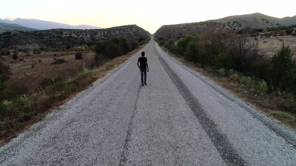 Man Walking Alone On The Road