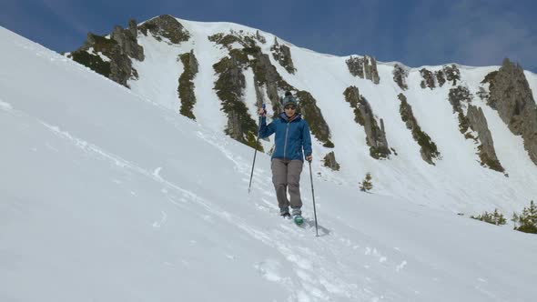 Young Woman with a Backpack Travels in the Mountains