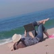 Woman Lying on Sand Beach Working Outside Vacation Time - VideoHive Item for Sale