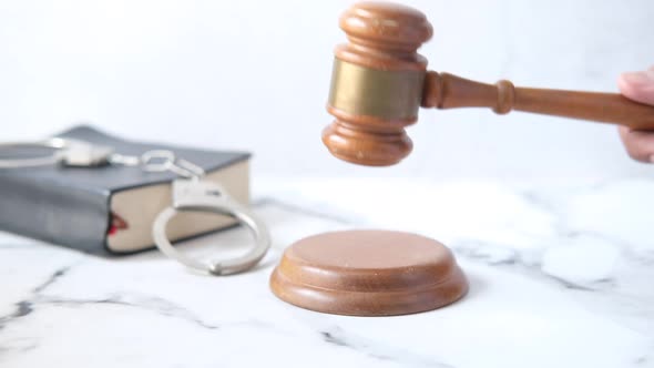 Person's Hand Striking the Gavel