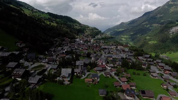 Flight over the village of Champéry in cloudy day