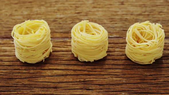 Roll of spaghetti on wooden table