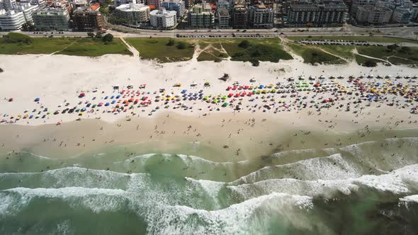 spring break, people on a beautiful white sand beach in Rio de Janeiro, Brazil. Aerial view