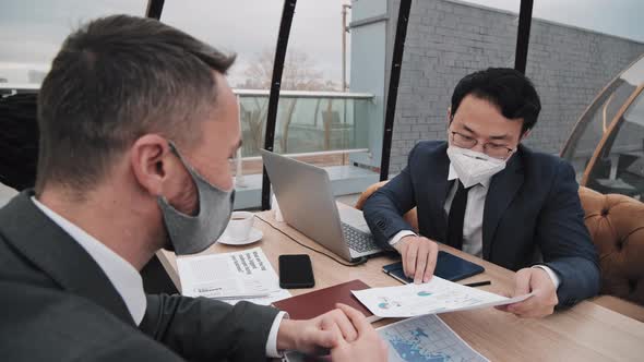 Coworkers in Masks in Restaurant