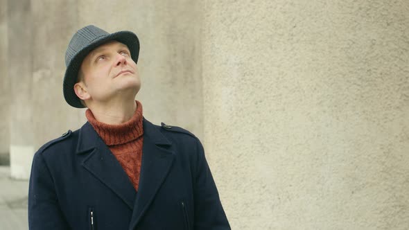 Portrait of a confident young man smiling at the camera. handsome man in a hat. Lifestyle concept