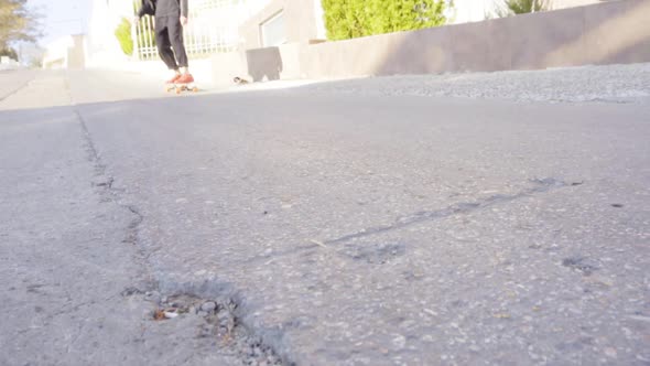 Young Man in Red Sneakers Skating in the Street