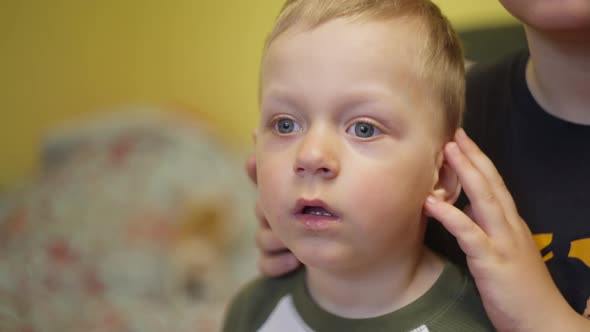 Little Boy Watching TV in the Bedroom