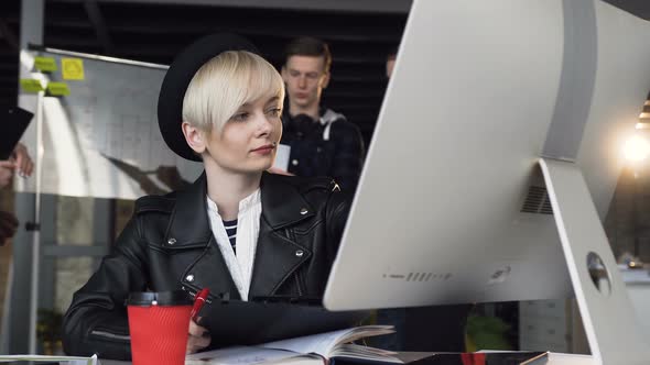 Busy Young Business Woman Working at Modern Office Using Computer Touch Screen, Looking at Monitor. 