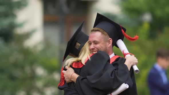 Best Friends Hugging Warmly and Laughing, Celebrating Graduation From University