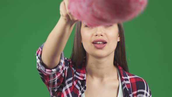 Young Happy Woman Cleaning Screen with a Duster