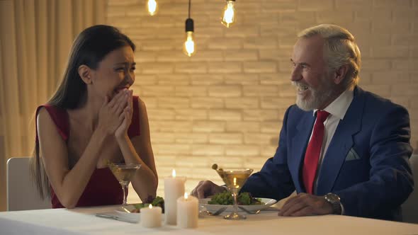 Beautiful Lady Laughing and Flirting With Old Rich Man in Restaurant, Escort