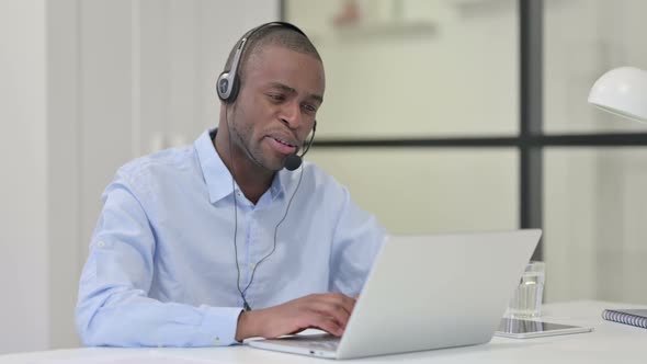Call Center African Man Talking Through Headset Customer Care