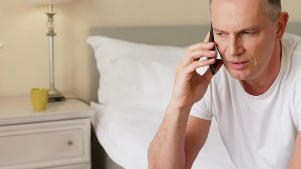 Man talking on mobile phone in bedroom 4k