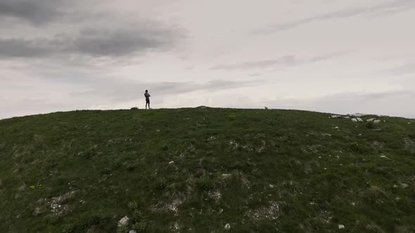 Man contemplating the panorama on the top of the mountains