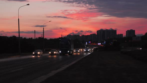 Beautiful Bright Orange Pink and Purple Sunset Sky City Highway Road Traffic