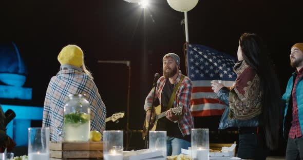 Male Singer in a Plaid Shirt with His Bassist