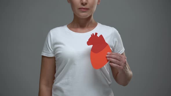 Worried Woman Holding Paper Heart Sign, Prevention of Stroke and Heart Attack