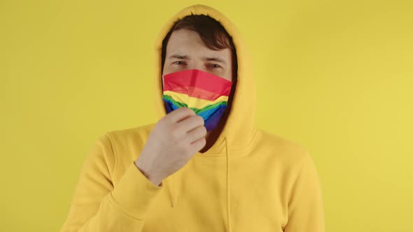 Man in Protective Rainbow Mask on Yellow Background