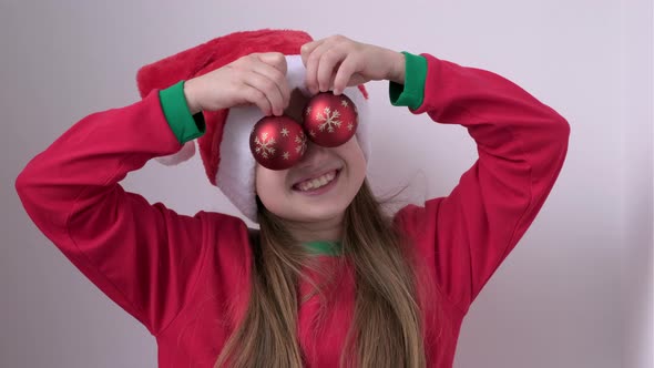 Portrait of Smiling Happy Little Girl in Christmas Santa Hat on White Background alt