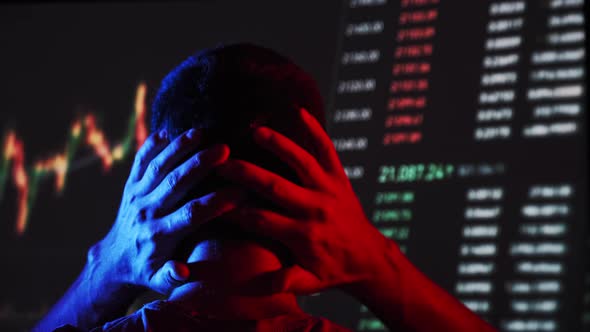 Trader Analyze Cryptocurrency Charts on a Big Screen in the Dark