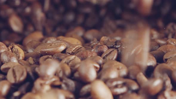 slow motion of coffee beans falling into a burlap sack