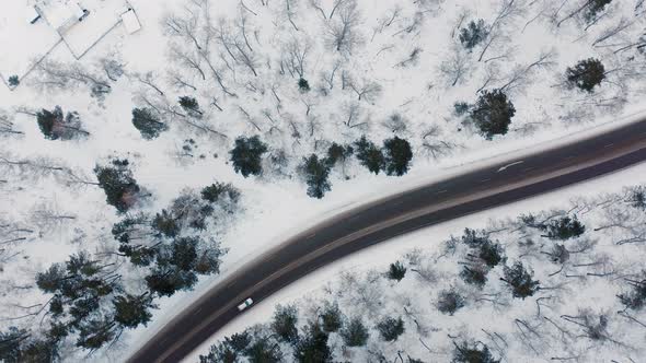 Riding a car on a winter road The drone view of winter driving Forest Winter Krasnoyarsk