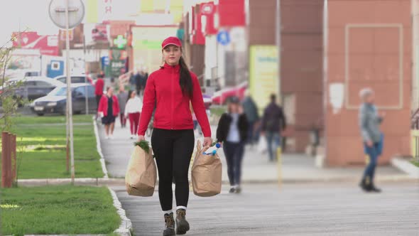 Courier (or a housewife, a cook ) with packages of food on street