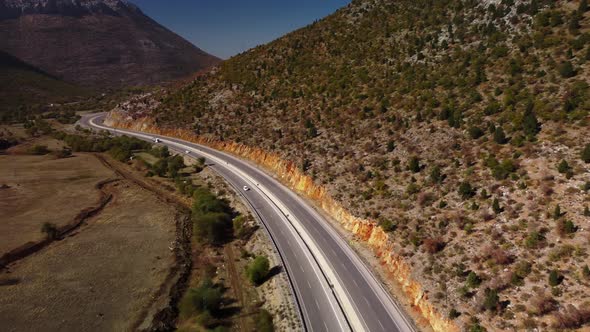 Cars are Driving on Asphalt Highway Lying Between Rocks and Mountains in Turkey