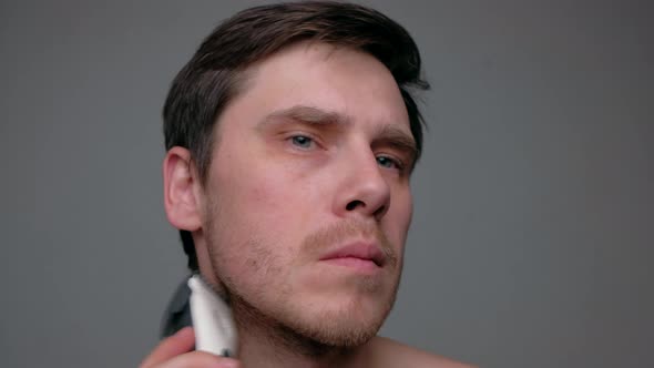 Man Shaving With Electric Razor