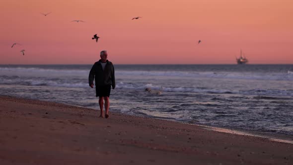 Senior Man Exercising At The  Beach