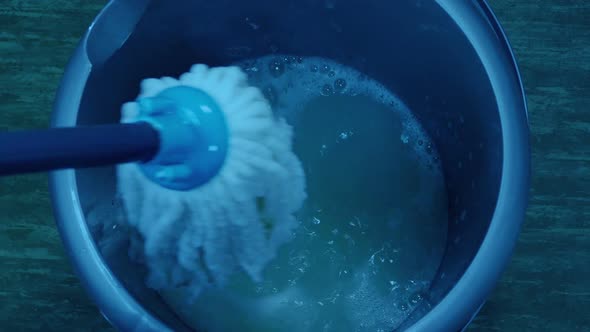 Person Mops The Floor With Soapy Water