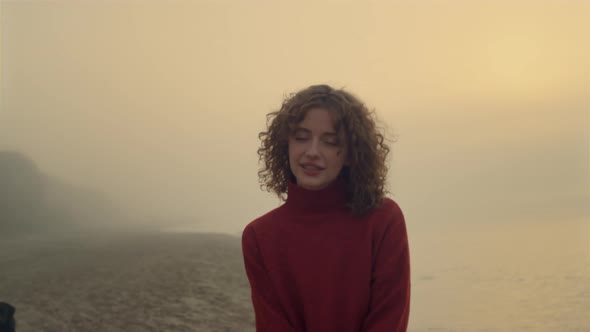 Smiling Woman Posing on Beach at Sunrise