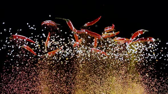 Mixture of ground spices slowly rise and fall against a black background.